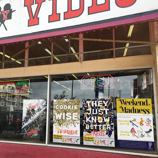 video storefront with 3 posters, saying "Cookie Wise," "They Just Know Better," and "Weekend Madness"
