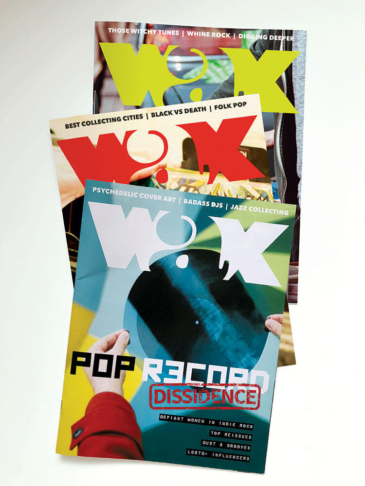 three magazines stacked, all with "wax" logo each in a different color to match the background photo