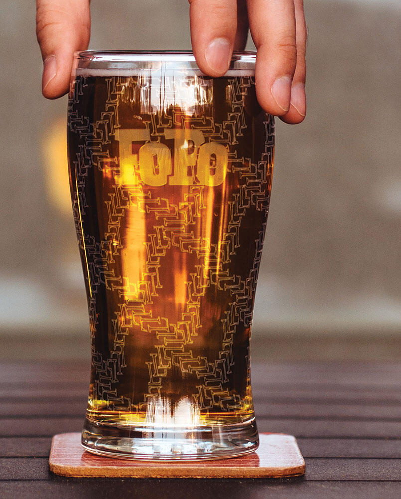 pint glass with etched FoPo logo and L repeating pattern