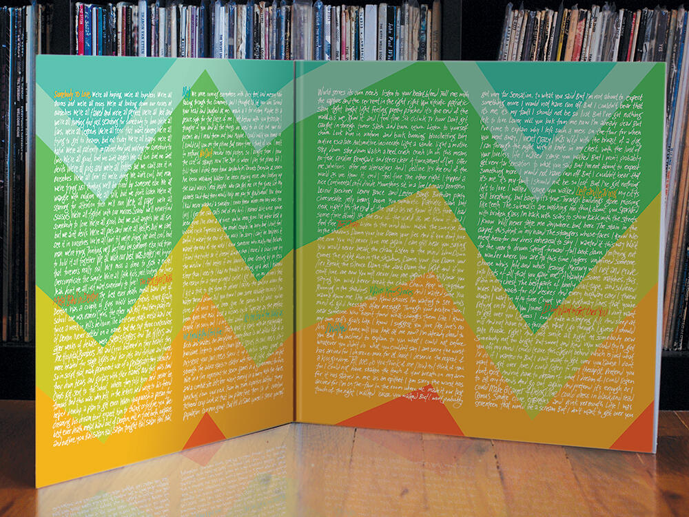 open record cover with blue/green/yellow/orange zig-zag design and song lyrics written in columns