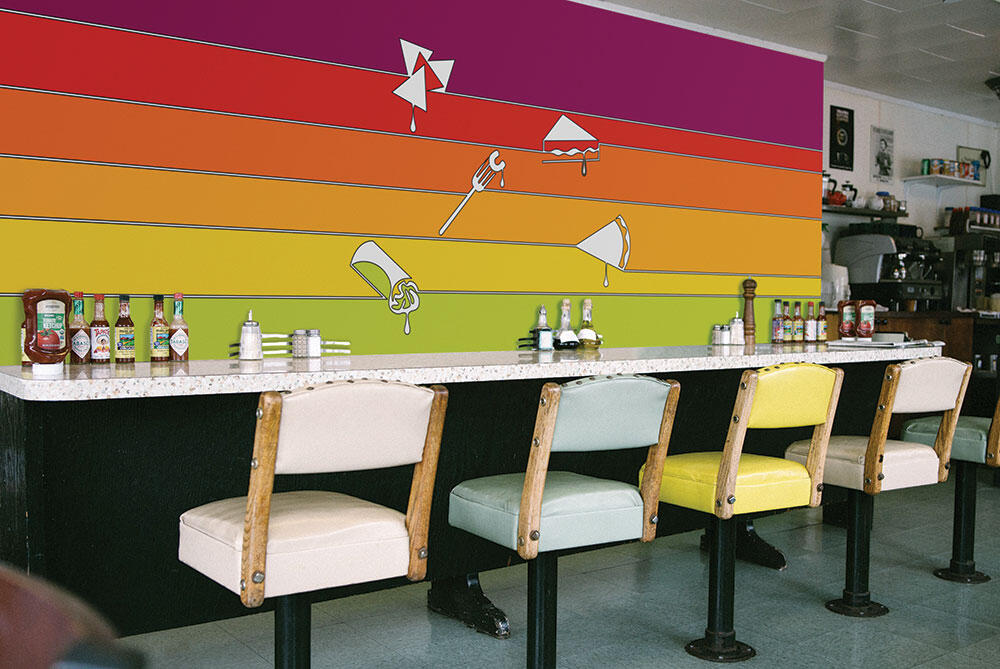 inside of diner with chairs in a row and wall in front with sunset colored stripes and food line drawings