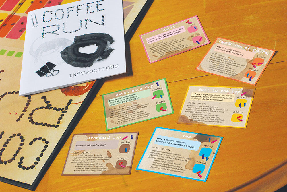 game cards, with text and coffee spills, and instruction manual in background