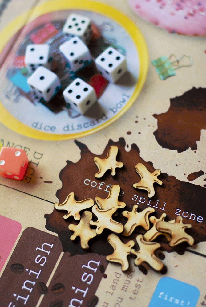 coffee spill laser-cut wood pieces and dice on game board